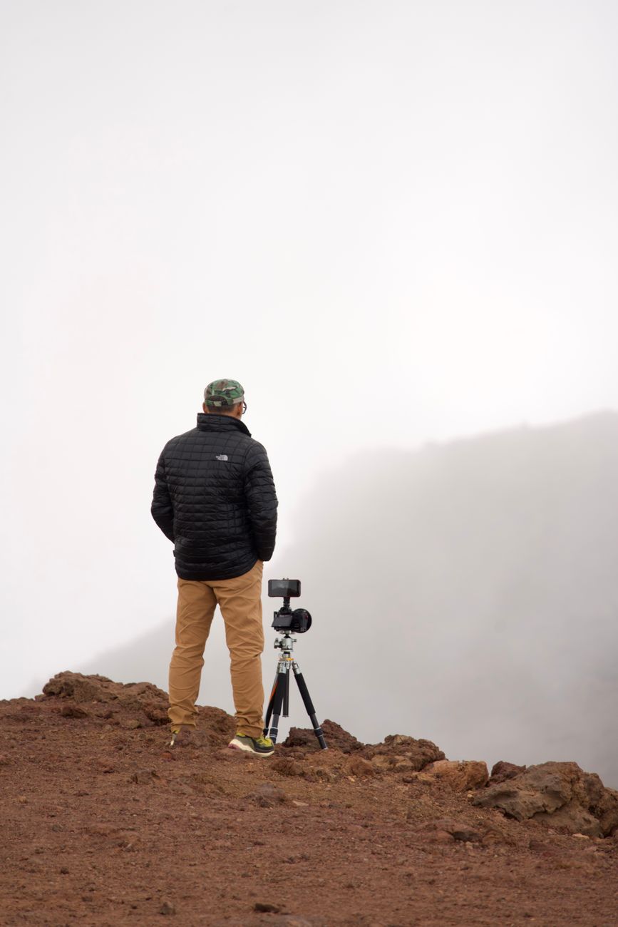 Travel photographer inspecting wilderness landscape